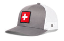 Introducing the Haka Hat Swiss Flag Trucker Hat | Switzerland Snapback—a gray and white trucker hat by Haka Hat, featuring a striking red patch with a white cross on the front. This classic snapback boasts a breathable white mesh back for all-day comfort, combining Swiss flag style with premium design.