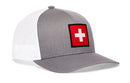 Showcasing classic style inspired by the Swiss flag, the Haka Hat Swiss Flag Trucker Hat is a gray and white snapback from Haka Hat, featuring a red patch with a white cross on the front panel.