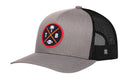 The Haka Hat Tampa Bay Trucker Hat | Black TPA X Football Snapback by Haka Hat features a gray and black mesh design with a circular patch displaying a palm tree, football, and the letters T and B in a crossed motif highlighted with red, yellow, and black accents—making it the perfect signature 5.0 trucker hat for any fan.