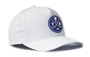 Introducing the Haka Hat Tampa Bay Hockey Performance 5-Panel Hat | TB X Flexfit Snapback by Haka Hat—a white baseball cap adorned with a blue circular logo featuring two crossed golf clubs, a palm tree, and the letters T and B on the front. Designed for comfort, this hat offers small ventilation holes on the side and a Flexfit sweatband for an adjustable, secure fit.