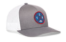 Introducing the Haka Hat Tennessee Football Trucker Hat | Columbia Blue TEN X Snapback by Haka Hat—a gray and white mesh snapback trucker hat featuring a circular blue and red patch on the front with the letters “TEN” and a small football image, making it the perfect accessory for fans of Nashville style.