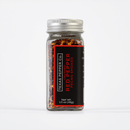 A clear glass jar with a silver lid holds Texas Salt Co. Pecan Smoked Crushed Red Pepper, topped with a black label. Boldly Texas-made, this 1.5 oz (43g) seasoning delivers rich, smoky flavor to any dish.