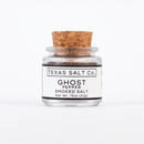 A small glass jar with a cork lid labeled Texas Salt Co. Ghost Pepper Smoked Salt, Net Wt. .75oz (21g), sits against a plain white background.