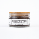 Texas Salt Co. Ghost Pepper Smoked Salt: A 3.5 oz glass jar with a wooden lid holds coarse smoked sea salt infused with Naga Jolokia for intense heat and flavor.