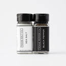 The Texas Salt Co. Salt & Pepper Set, featuring sea salt and black pepper jars, offers a stylish everyday seasoning duo made in the USA by Texas Salt Co., beautifully displayed on a simple white background.
