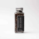 A clear glass jar of Texas Salt Co. Thick Hickory Smoked Peppercorns, Net Wt. 4.5 oz (128g), displays rich hickory smoked seasoning and features the Texas Salt Co brand label against a plain white background.