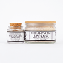 Two clear glass jars with cork lids contain Texas Salt Co. Mountain Spring Peruvian Salt. The 1oz (28g) jar and the 5oz (142g) jar both feature white labels with black text and the Texas Salt Co brand name.