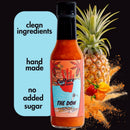 A bottle of Culture Hot Sauce The Don by Culture Hot Sauce is displayed in front of a pineapple and peppers, accompanied by text that highlights: clean ingredients, handmade, no added sugar. Infused with the bold flavor of Szechuan peppercorn, this original recipe delivers a unique kick. The label showcases a red handprint and a beach scene.
