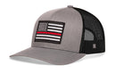 Show your support for firefighters with the Haka Hat Thin Red Line Trucker Hat | Black Fire Snapback from Haka Hat—a gray and black trucker hat featuring a mesh back and a patch with a black-and-white American flag accented by a single red stripe.