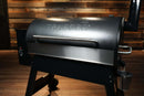 Pimp My Grill® Bodyguard Stainless Steel Grease & Paint Protector attached to the front of a black-lidded pellet grill.