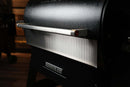 A Pimp My Grill® Bodyguard Stainless Steel Grease & Paint Protector installed on the front of a black Ridgeline XL pellet grill lid.