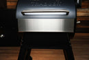 Pimp My Grill® Bodyguard Stainless Steel Grease & Paint Protector for Traeger Pro 575 / Pro 22 / Redland / Ironwood 650 attached to the front of a grill lid.