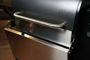 Pimp My Grill® Bodyguard Stainless Steel Grease & Paint Protector attached to the front of a grill below the handle as a shield.