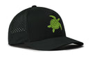 The Haka Hat Turtle Performance 5-Panel Hat by Haka Hat features a black design with small ventilation holes on the sides, a green turtle graphic on the front panel, and is equipped with a Flexfit sweatband for added comfort.