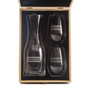 A Wine Decanter - The Classic glass decanter and two personalized stemless wine glasses, each engraved with a name, resting in a wooden presentation box.