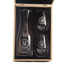 A Wine Decanter - The Medalist featuring a personalized decanter and two stemless wine glasses, each etched with a letter M in a circular frame, presented in an open wooden gift box.