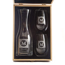 A Wine Decanter - The Heirloom set featuring a glass decanter and two stemless wine glasses, each etched with a decorative letter M, resting inside a personalized wooden gift box.