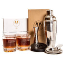 Swanky Badger Whiskey Essentials Bundle including two personalized SMITH-engraved whiskey glasses, a cocktail shaker, jigger, strainer, and black leather coasters, displayed with their product boxes.