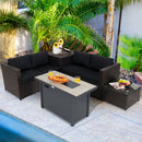 The DirectDeals 5-Piece Patio Furniture Set with Propane Fire Pit Table features two black wicker loveseats, a small side table, and a fire pit table, set by tropical plants and a swimming pool.