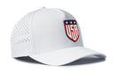 Introducing the Haka Hat USA Shield Performance 5-Panel Hat—a white Flexfit snapback from Haka Hat that showcases the iconic USA shield logo with three stars above it on the front panel. Designed for comfort, this America Flexfit Snapback features side ventilation holes and a Flexfit sweatband.