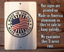 Made in the USA sign on a wooden background with text about sign material and durability.