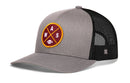 The Haka Hat Washington DC Trucker Hat is a black and gray mesh snapback featuring a round maroon patch with yellow crossed lines, white W, A, S lettering, and a small white football icon.