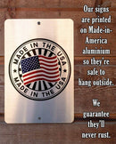 Metal sign with 'Made in the USA' design on a wooden background