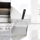 A large stainless steel XL Stainless Steel Griddle Shovel – 5 Cup Food Scoop & Spatula by Fox Run Brands with a black handle, standing upright on a countertop.