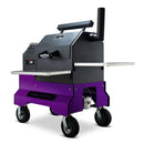 The Yoder Smokers YS480S Competition Pellet Grill with wire shelves, in modern black and purple, features a chimney, large caster wheels, and supports direct-flame grilling. Shown on a white background.