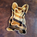 The French Bulldog Wood Tray by Two Acre Woodworks features layered wood grains and a charming sitting dog shape—an ideal handcrafted organizer and unique gift for dog lovers, perfect on any brown leather surface.